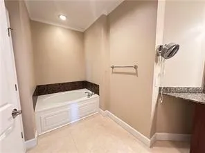 Full bath with a garden tub, vanity, light tile patterned flooring, recessed lighting, and ornamental molding