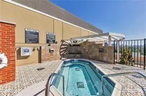 View of swimming pool featuring patio surround and a community hot tub