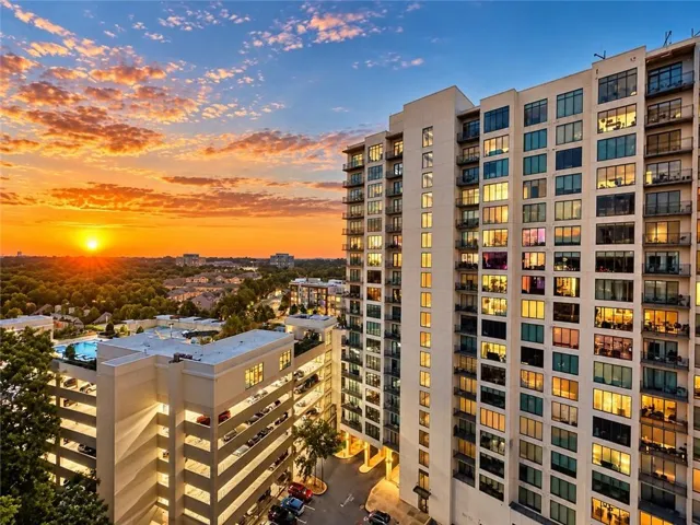 High-rise building with extensive window lines and private balconies as well as pool view