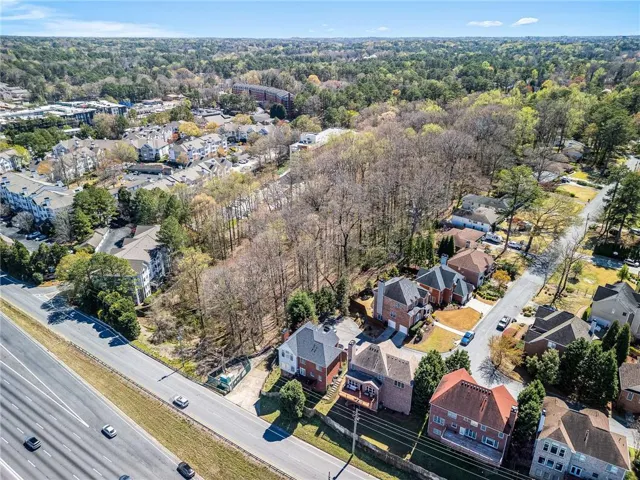 Drone / aerial view featuring a wooded view and a residential view