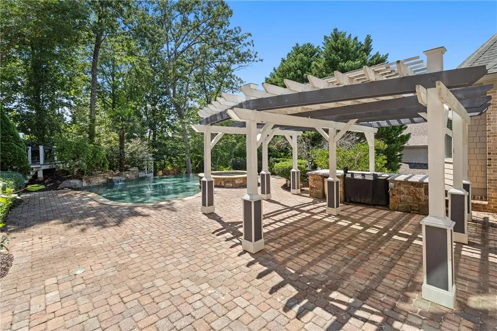 View of patio featuring a pool with connected hot tub and a pergola