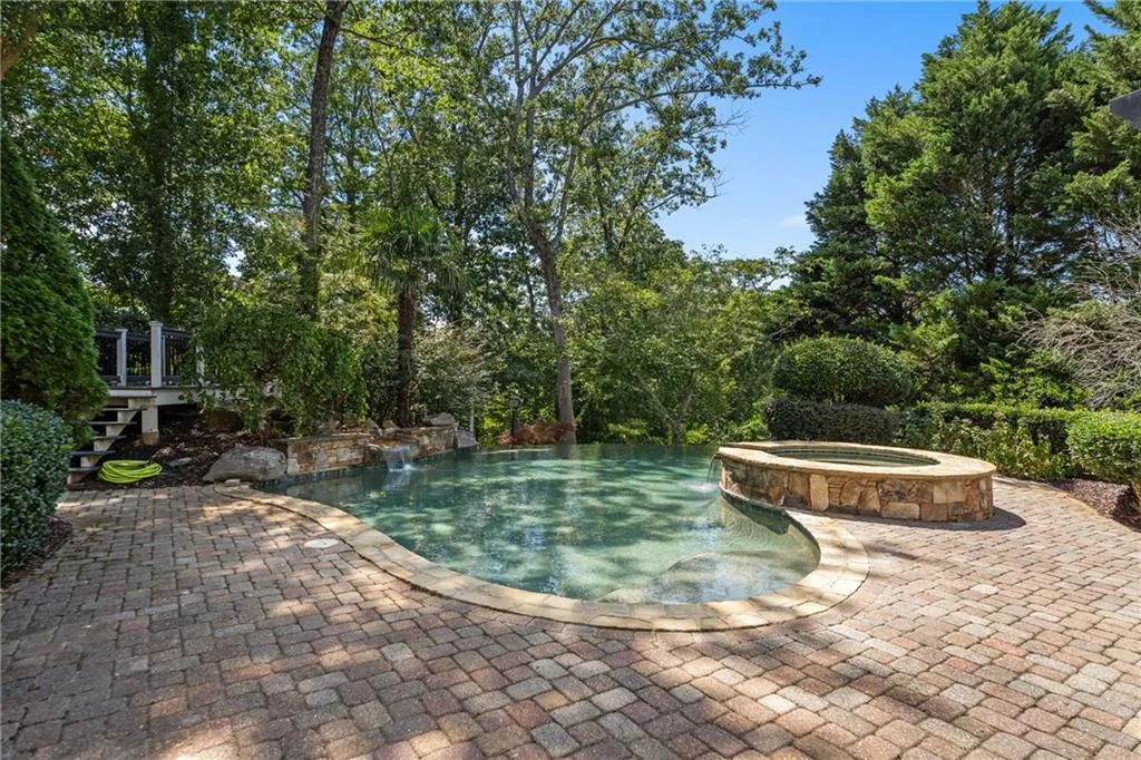 View of swimming pool with a pool with connected hot tub and a patio area