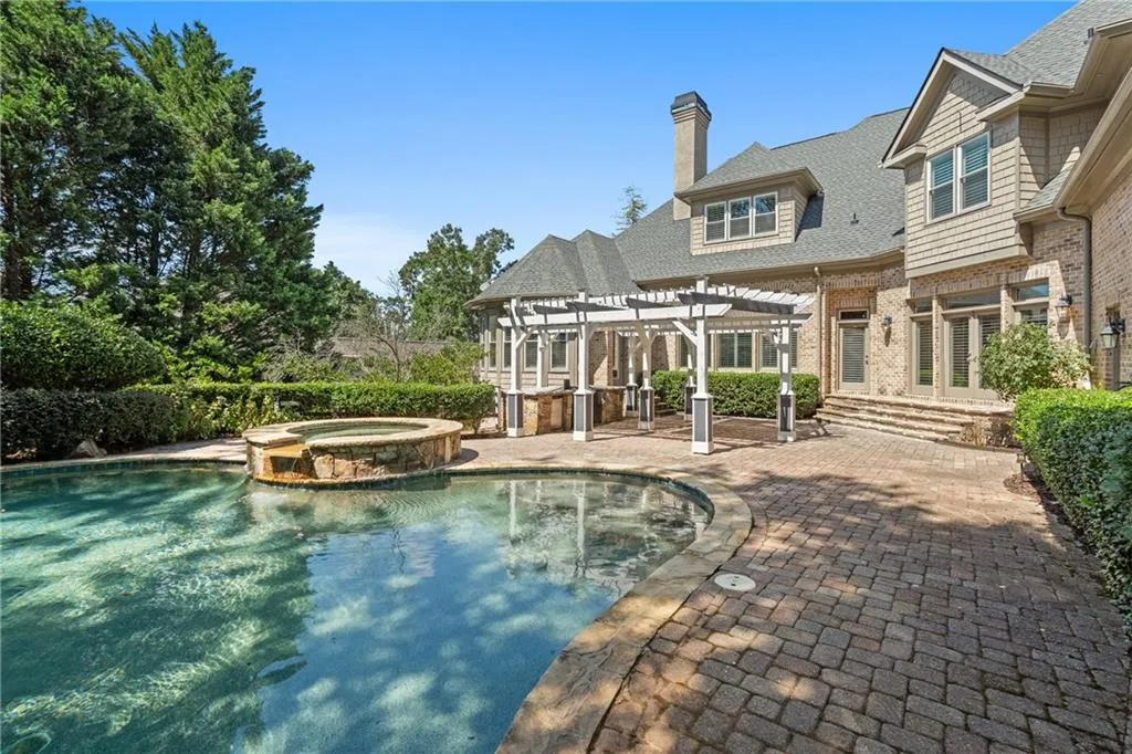 View of swimming pool with a pergola, a patio, and a pool with connected hot tub