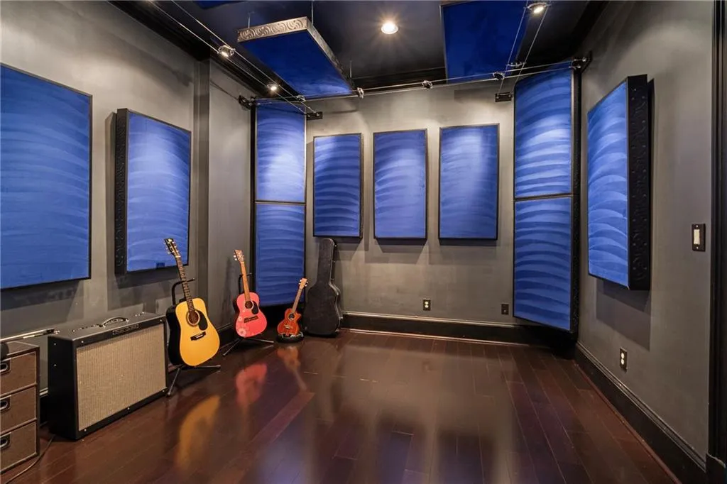 Recreation room featuring wood finished floors and baseboards