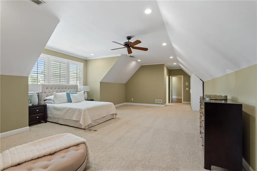Upper Bedroom with light colored carpet, recessed lighting, vaulted ceiling, ornamental molding, and ceiling fan
