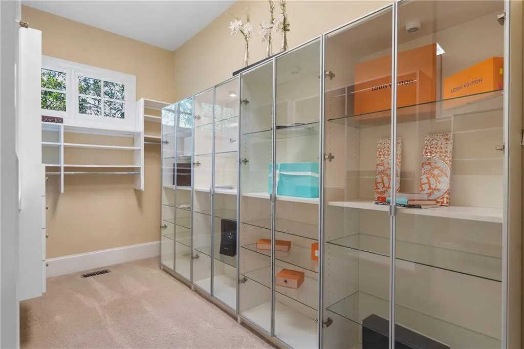 Walk in closet with carpet floors