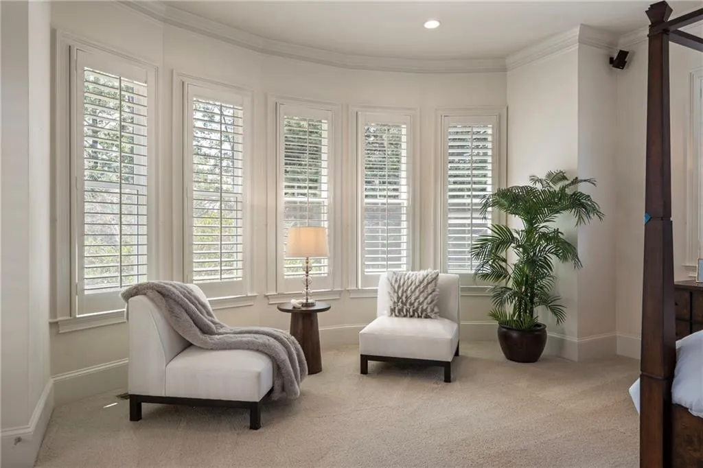 Sitting room with carpet floors and crown molding