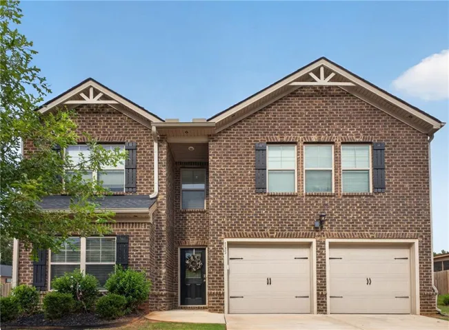 Brick facade with decorative gables and dark shutters