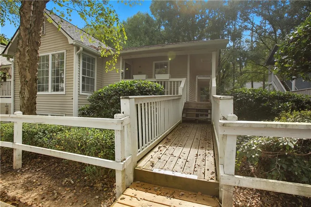 View of front of home featuring a fenced front yard and covered porch