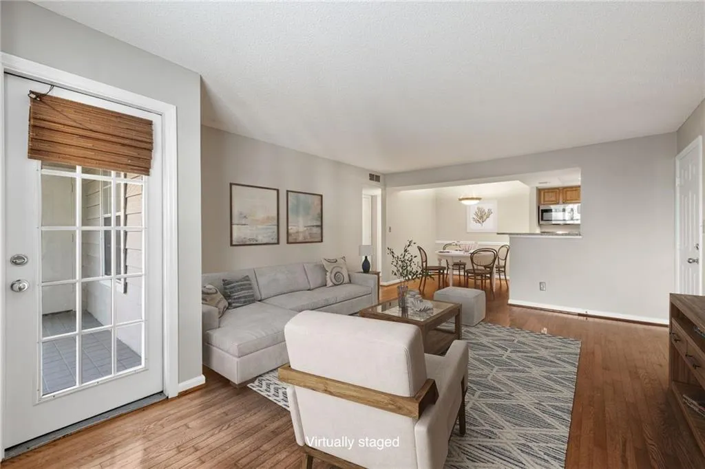 Hardwood flooring throughout the living area, dining area, and kitchen