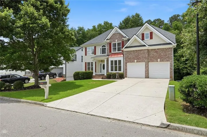 Traditional two-story residence with a brick and siding facade