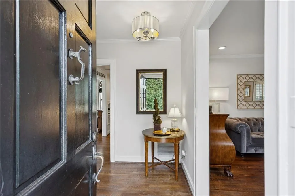 Entrance foyer featuring crown molding, dark wood-type flooring, and recessed lighting