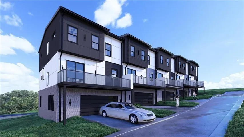 Contemporary multi-level townhome featuring a dark and light panel facade, an integrated garage, and a private balcony with glass railings