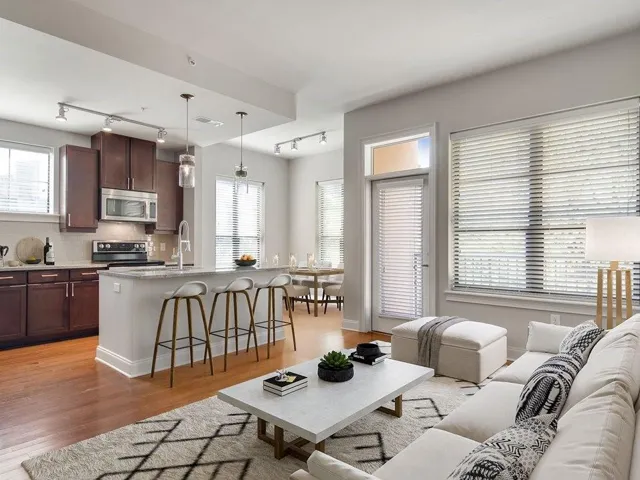 Living room with plenty of natural light, light hardwood / wood-style flooring, and rail lighting