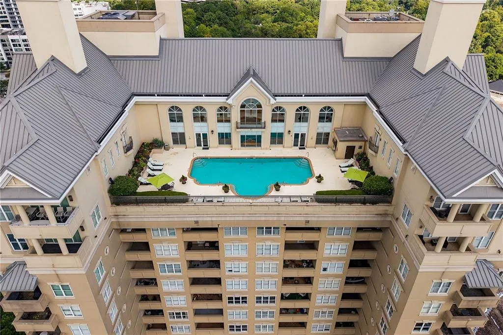 Rooftop amenity deck featuring a swimming pool, surrounding patio, and landscaping