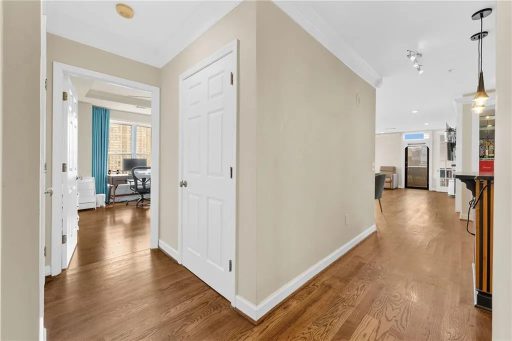 Hardwood flooring extends throughout, complemented by crown molding and recessed lighting