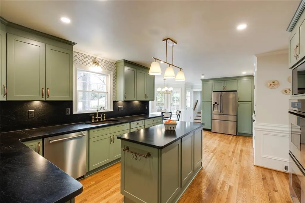 Recently renovated custom kitchen with high-end cabinetry & honed granite.