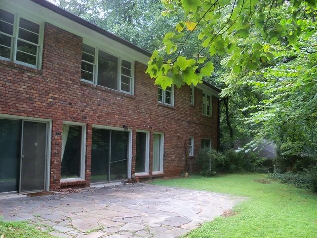 Back of house with a lawn and a patio area