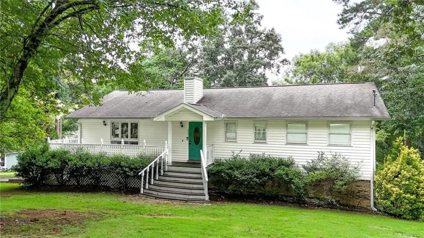 Classic ranch-style home featuring a covered front porch with multi-step entry, horizontal siding exterior, and a composite or asphalt shingle roof