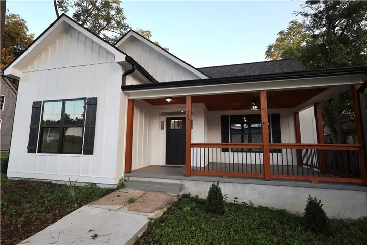 White board-and-batten exterior with contrasting black window shutters