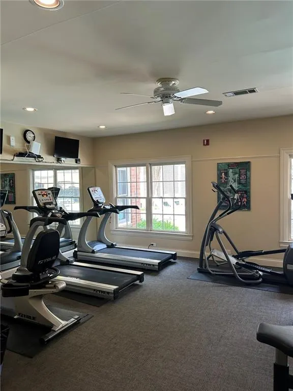 Exercise room featuring carpet, ceiling fan, baseboards, and recessed lighting