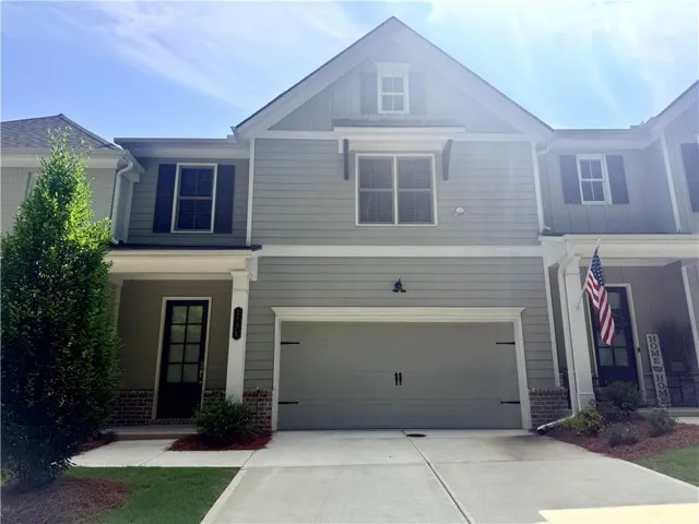 Light gray siding exterior featuring a prominent two-car garage with