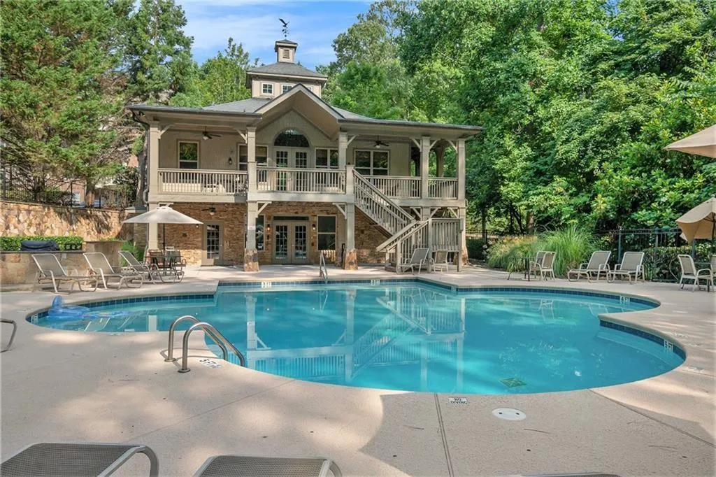 Community pool featuring a patio, stairs, ceiling fan, and french doors