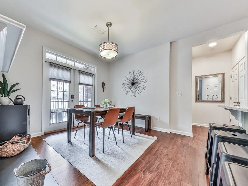 Dining area featuring independent washer and dryer, dark wood-type flooring, and french doors