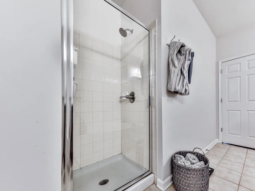 Bathroom featuring a stall shower and tile patterned flooring