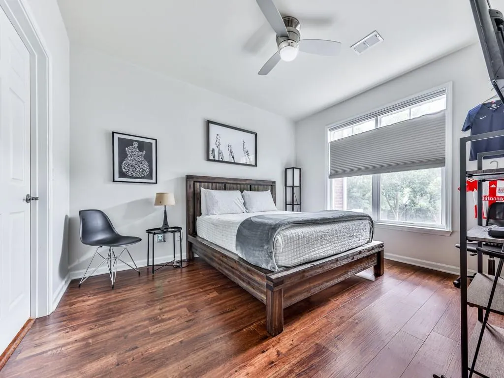 Bedroom featuring wood finished floors and a ceiling fan
