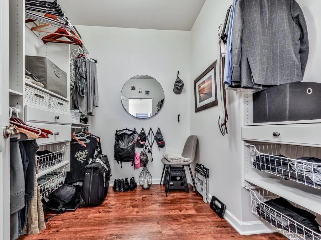 Walk in closet featuring wood finished floors