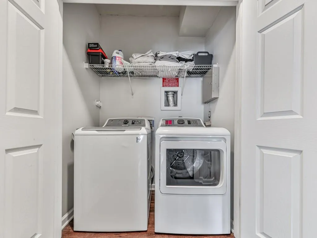 Laundry room with separate washer and dryer and baseboards