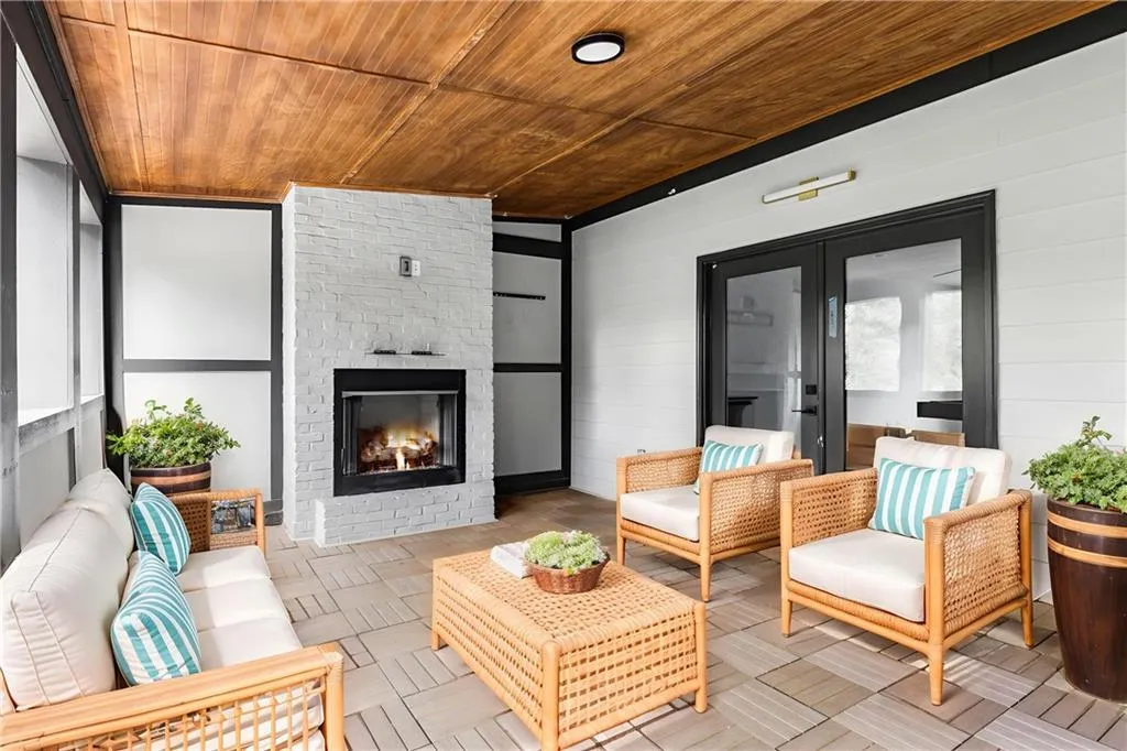 View of patio / terrace featuring an outdoor living space with a fireplace and french doors