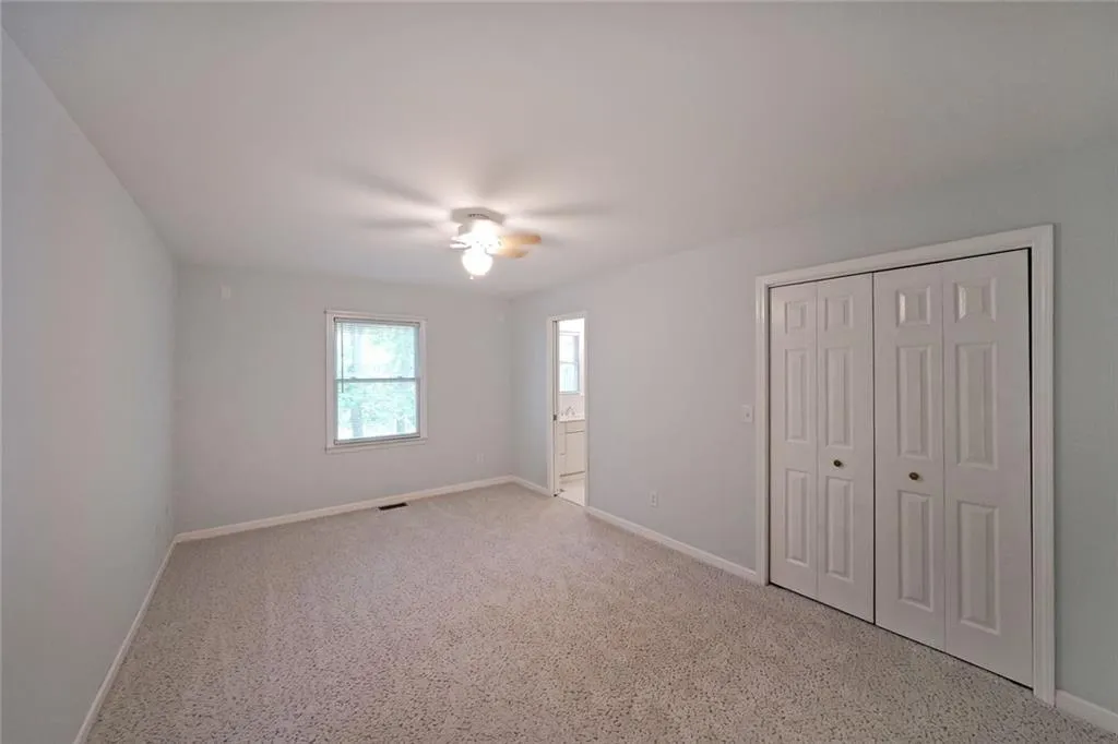 Unfurnished bedroom featuring baseboards, a ceiling fan, carpet flooring, and a closet