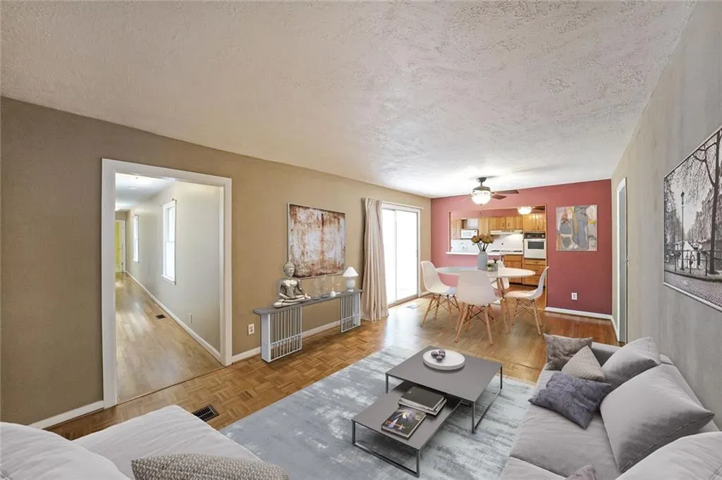 Living room with a textured ceiling, baseboards, a ceiling fan, and parquet flooring