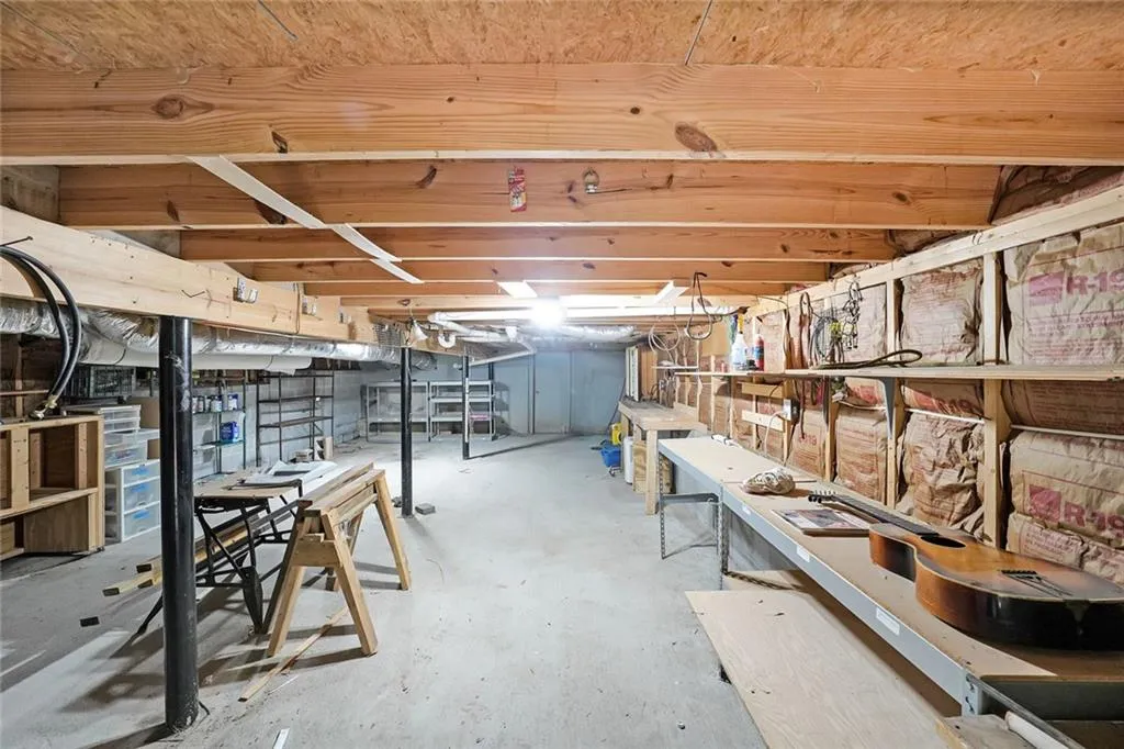 Unfinished basement featuring a workshop area