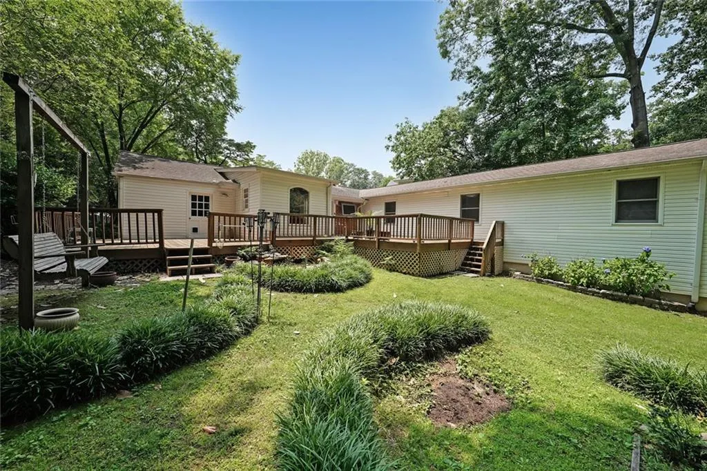 View of grassy yard with a deck