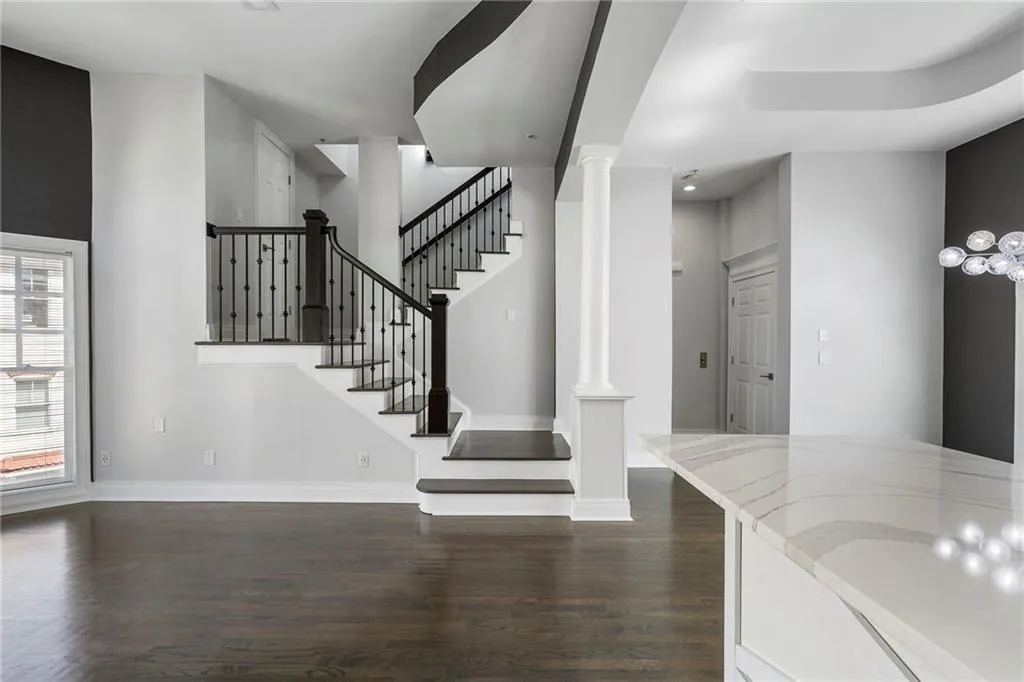 Foyer entrance featuring dark wood-type flooring and stairs Foyer entrance featuring dark wood-type flooring and stairs