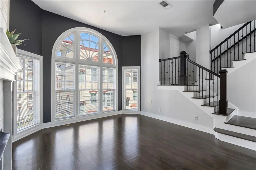 Entryway featuring dark wood finished floors, stairway, and a high ceiling Entryway featuring dark wood finished floors, stairway, and a high ceiling