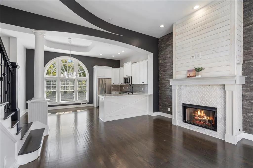 Unfurnished living room featuring stairs, dark wood-style floors, a fireplace, recessed lighting, and a chandelier Unfurnished living room featuring stairs, dark wood-style floors, a fireplace, recessed lighting, and a chandelier