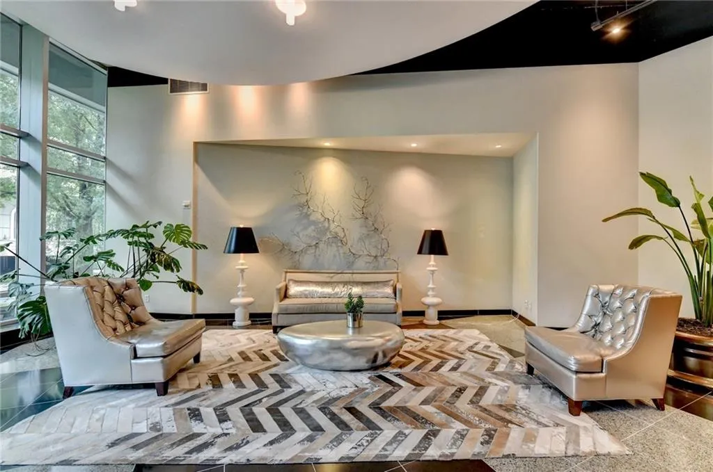 Lobby area featuring full-height windows, recessed lighting, and a black and white chevron pattern area rug