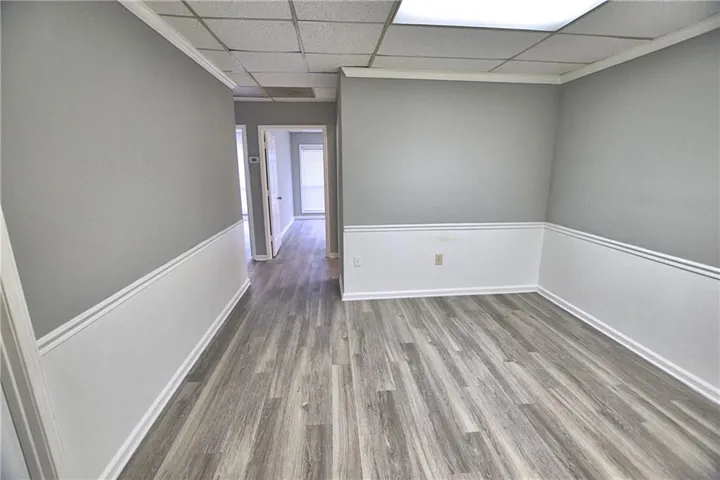 Wood-finish flooring with wainscoting and crown molding