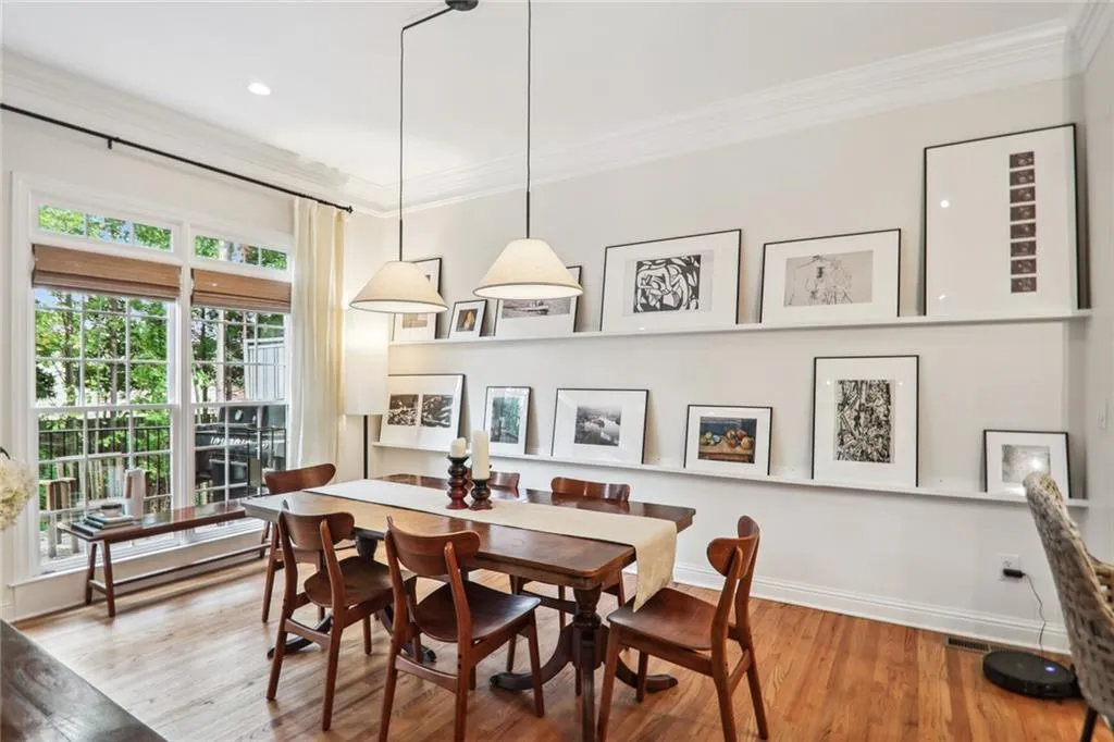 Dining area featuring crown molding and hardwood / wood-style flooring
