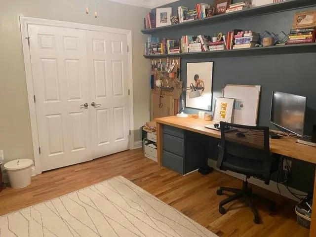 Home office with light hardwood / wood-style flooring