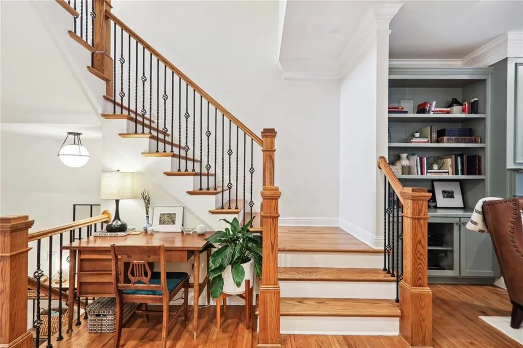 Stairs with ornamental molding and hardwood / wood-style flooring