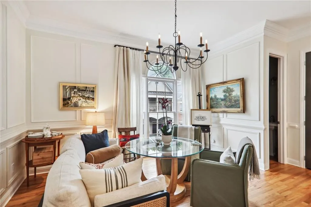 Dining space featuring ornamental molding, a notable chandelier, and light wood-type flooring