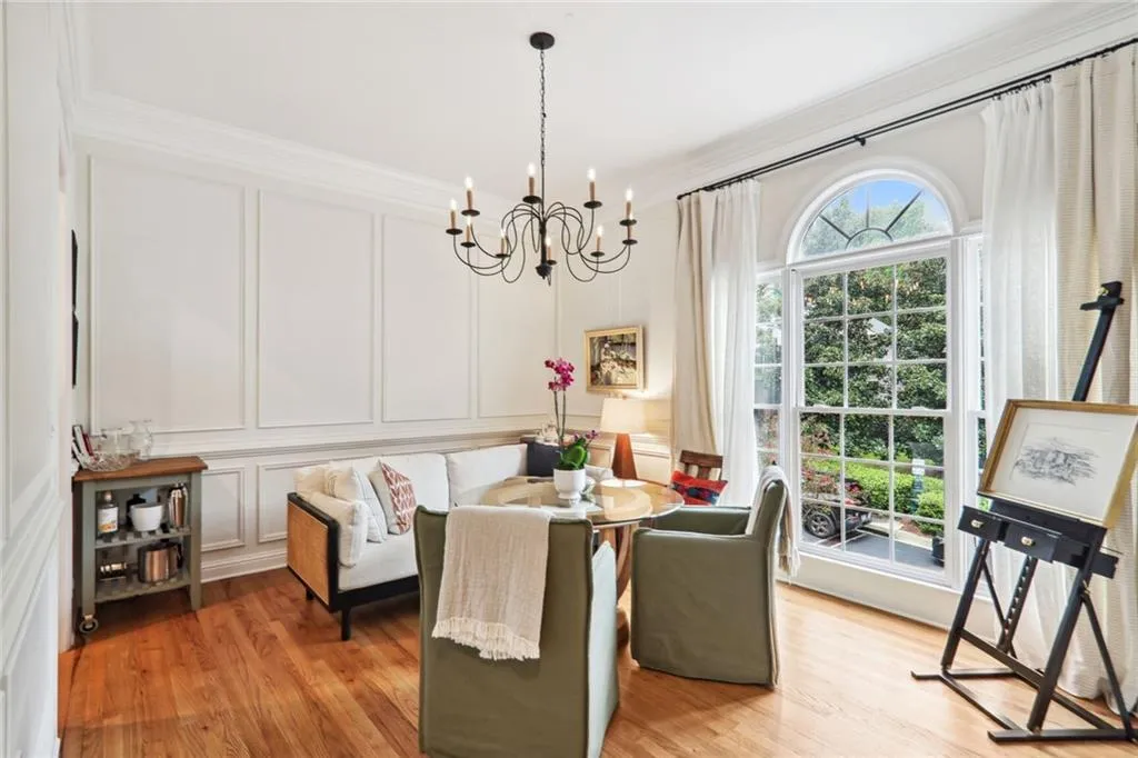 Dining room featuring ornamental molding, a chandelier, and light wood-type flooring