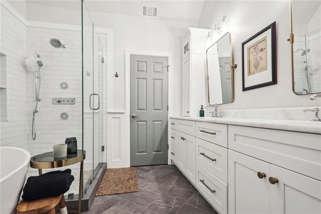 Bathroom featuring vanity and independent shower and bath