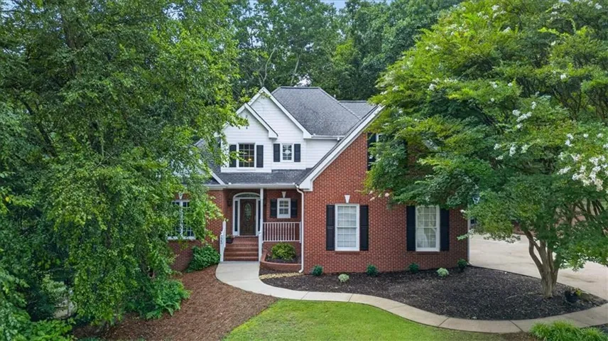 Brick and siding exterior featuring a multi-gable roofline