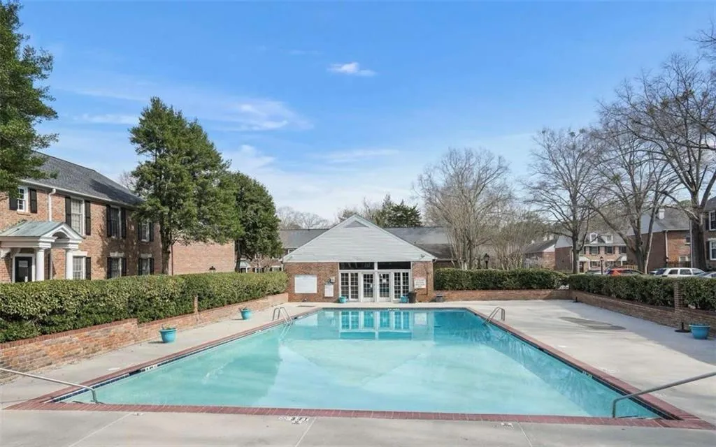 Community pool with a patio, a residential view, french doors, and an outdoor structure
